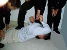 Published on 2/17/2005 		黑龙江省依兰县恶警酷刑折磨法轮功学员演示（图）
