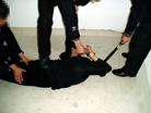 Published on 2/17/2005 		黑龙江省依兰县恶警酷刑折磨法轮功学员演示（图）
